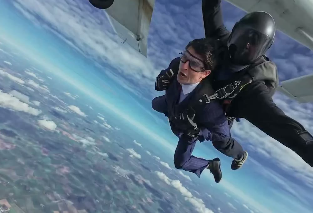 A tandem skydive just out of the plane, the front jumper in a suit